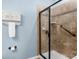 Tiled shower stall with a black framed glass door and a convenient grab bar for accessibility at 23147 Whimbrel Cir, Fort Mill, SC 29707