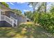 A spacious backyard featuring lush green grass and mature trees next to the painted home at 2322 Hedgewood Cir, Gastonia, NC 28052