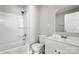 This renovated bathroom features a shower-tub combo, and a modern white vanity with a mirror at 2322 Hedgewood Cir, Gastonia, NC 28052