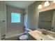 Bathroom with white subway tile surround, a window for natural light, and classic fixtures at 2322 Hedgewood Cir, Gastonia, NC 28052