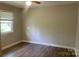 Cozy bedroom with wood-look floors, neutral paint, and a window for natural light at 2322 Hedgewood Cir, Gastonia, NC 28052