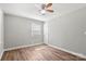 This bedroom features hardwood floors, a ceiling fan, and a window for natural light at 2322 Hedgewood Cir, Gastonia, NC 28052