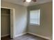 Bright bedroom with wood-look floors, neutral paint, closet, and a window for natural light at 2322 Hedgewood Cir, Gastonia, NC 28052