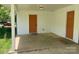 Neutral painted carport with concrete floor, an exterior door and space for parking vehicles at 2322 Hedgewood Cir, Gastonia, NC 28052