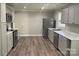 Bright kitchen with stainless steel appliances, new laminate floors, neutral paint, and white countertops at 2322 Hedgewood Cir, Gastonia, NC 28052