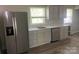 Clean kitchen featuring a stainless steel refrigerator, sink, dishwasher, and lots of natural light at 2322 Hedgewood Cir, Gastonia, NC 28052