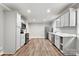Updated kitchen showcasing white cabinets, stainless steel appliances, marble countertops, and wood-look flooring at 2322 Hedgewood Cir, Gastonia, NC 28052