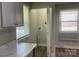 A view from the kitchen into the laundry room, which includes a window, and washer/dryer hookups at 2322 Hedgewood Cir, Gastonia, NC 28052