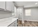 Bright laundry room features modern fixtures, hardwood floors, and a gray countertop at 2322 Hedgewood Cir, Gastonia, NC 28052