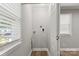 Bright laundry room features modern fixtures, hardwood floors, and natural light from the window at 2322 Hedgewood Cir, Gastonia, NC 28052