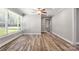 The bright living room offers hardwood floors and natural lighting from a large set of windows at 2322 Hedgewood Cir, Gastonia, NC 28052