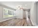 This living room has hardwood floors, natural light from the windows, and white trim throughout at 2322 Hedgewood Cir, Gastonia, NC 28052