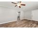 Bright living room with wood-look floors, crown molding, neutral paint, ceiling fan, and open doorway to the kitchen at 2322 Hedgewood Cir, Gastonia, NC 28052
