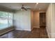 Open-concept living room with laminate flooring, neutral paint, modern ceiling fan, and a large window at 2322 Hedgewood Cir, Gastonia, NC 28052