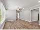 Spacious living room featuring wood-look floors, large windows, crown molding, neutral paint, and ceiling fan at 2322 Hedgewood Cir, Gastonia, NC 28052