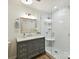 Modern bathroom featuring a glass shower, gray vanity with marble top, and wood-look floors at 2401 Birnen Dr, Charlotte, NC 28210