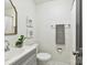 Clean powder room with gray vanity, gray towel and decorative art at 2401 Birnen Dr, Charlotte, NC 28210
