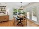 Bright dining area features a dark round table with wood chairs and french doors at 2401 Birnen Dr, Charlotte, NC 28210