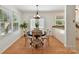 Bright dining area features a dark round table with wood chairs and a modern chandelier above at 2401 Birnen Dr, Charlotte, NC 28210