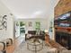 Cozy living room with a brick fireplace, hardwood floors, and view of the front yard at 2401 Birnen Dr, Charlotte, NC 28210