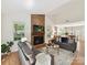 Spacious living room with a brick fireplace, hardwood floors, and an open layout at 2401 Birnen Dr, Charlotte, NC 28210