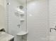 Close-up of the glass shower with white subway tile and a shower bench at 2401 Birnen Dr, Charlotte, NC 28210