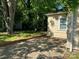 Back of house with driveway and partial view of the yard and shed at 2433 Booker Ave, Charlotte, NC 28216