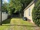 Fenced backyard space ready for outdoor activities and gatherings, with some trash cans in view at 2433 Booker Ave, Charlotte, NC 28216