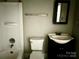 Simple bathroom with a tub/shower combo, toilet, and a vanity with sink at 2433 Booker Ave, Charlotte, NC 28216