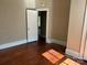 Bedroom featuring hardwood floors, natural light and doorway to another room at 2433 Booker Ave, Charlotte, NC 28216