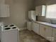 Functional kitchen featuring white appliances, cabinets, and a double-basin sink at 2433 Booker Ave, Charlotte, NC 28216