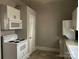 Efficient kitchen with white appliances, including a microwave and cooktop at 2433 Booker Ave, Charlotte, NC 28216