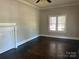 Bright living room with hardwood floors, classic fireplace mantel, and natural light from the windows at 2433 Booker Ave, Charlotte, NC 28216