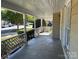 Inviting covered front porch with white railing, offering a relaxing outdoor space with views of neighborhood at 2433 Booker Ave, Charlotte, NC 28216