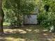 A small shed sits on the property surrounded by trees at 2433 Booker Ave, Charlotte, NC 28216