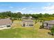 Aerial view of a home's backyard featuring a patio perfect for outdoor entertaining and mature trees at 2511 Carnation Dr, Harrisburg, NC 28075