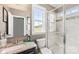 Modern bathroom with a glass-enclosed shower, granite countertop, and natural light at 2511 Carnation Dr, Harrisburg, NC 28075