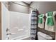 Well-lit bathroom featuring a shower-tub combination with a white shower curtain and coordinated towels at 2511 Carnation Dr, Harrisburg, NC 28075