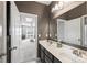 Bright bathroom featuring double sinks, a large mirror, and stylish vanity lighting at 2511 Carnation Dr, Harrisburg, NC 28075