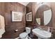 Charming powder room with wood paneled walls, a unique sink, and stylish decor at 2511 Carnation Dr, Harrisburg, NC 28075
