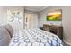 This carpeted bedroom has bright decor, cool colors, wall art, and a relaxing atmosphere at 2511 Carnation Dr, Harrisburg, NC 28075