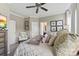 Serene bedroom with neutral tones, a ceiling fan, and comfortable furnishings at 2511 Carnation Dr, Harrisburg, NC 28075
