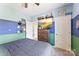 The bedroom features unique wall decor, carpet, and neutral lighting for a warm space at 2511 Carnation Dr, Harrisburg, NC 28075