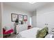 Bright bedroom featuring white walls, artwork, a white dresser, and accent seating at 2511 Carnation Dr, Harrisburg, NC 28075