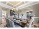 Formal dining area featuring coffered ceilings and a modern chandelier with views of the office space at 2511 Carnation Dr, Harrisburg, NC 28075