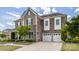 Beautiful two-story home featuring stone and shingle accents and a two-car garage at 2511 Carnation Dr, Harrisburg, NC 28075