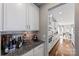 Kitchen area featuring white cabinets, granite countertops, and stainless steel appliances at 2511 Carnation Dr, Harrisburg, NC 28075
