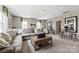 Large living room featuring a sectional sofa, coffee table, a bar table, and large windows at 2511 Carnation Dr, Harrisburg, NC 28075