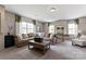 Spacious living room with large sectional sofa, coffee table, mini bar, and plenty of natural light at 2511 Carnation Dr, Harrisburg, NC 28075