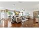 Bright living room features hardwood floors, a fireplace, and large windows at 2511 Carnation Dr, Harrisburg, NC 28075